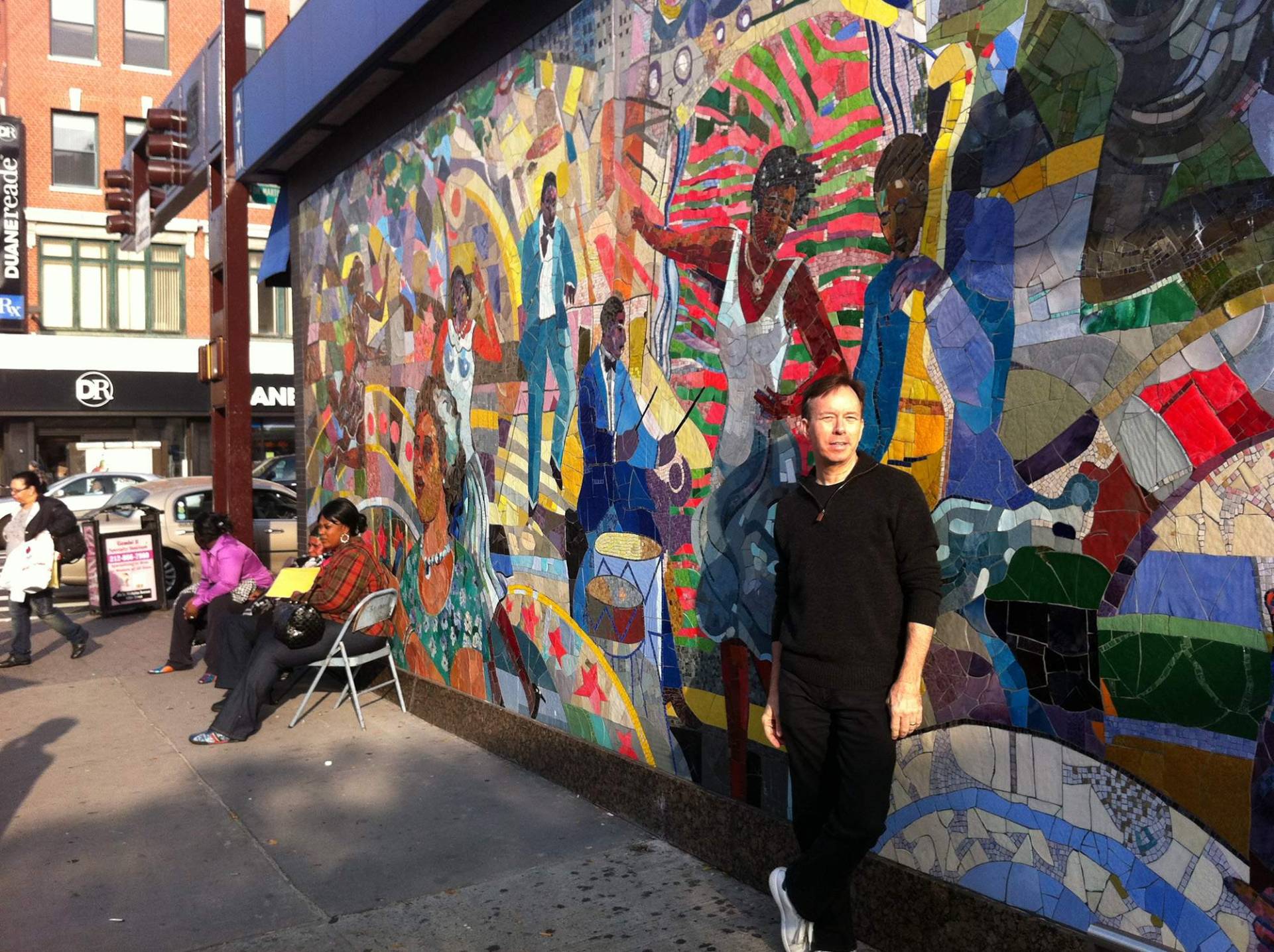 In front of a Harlem mural
